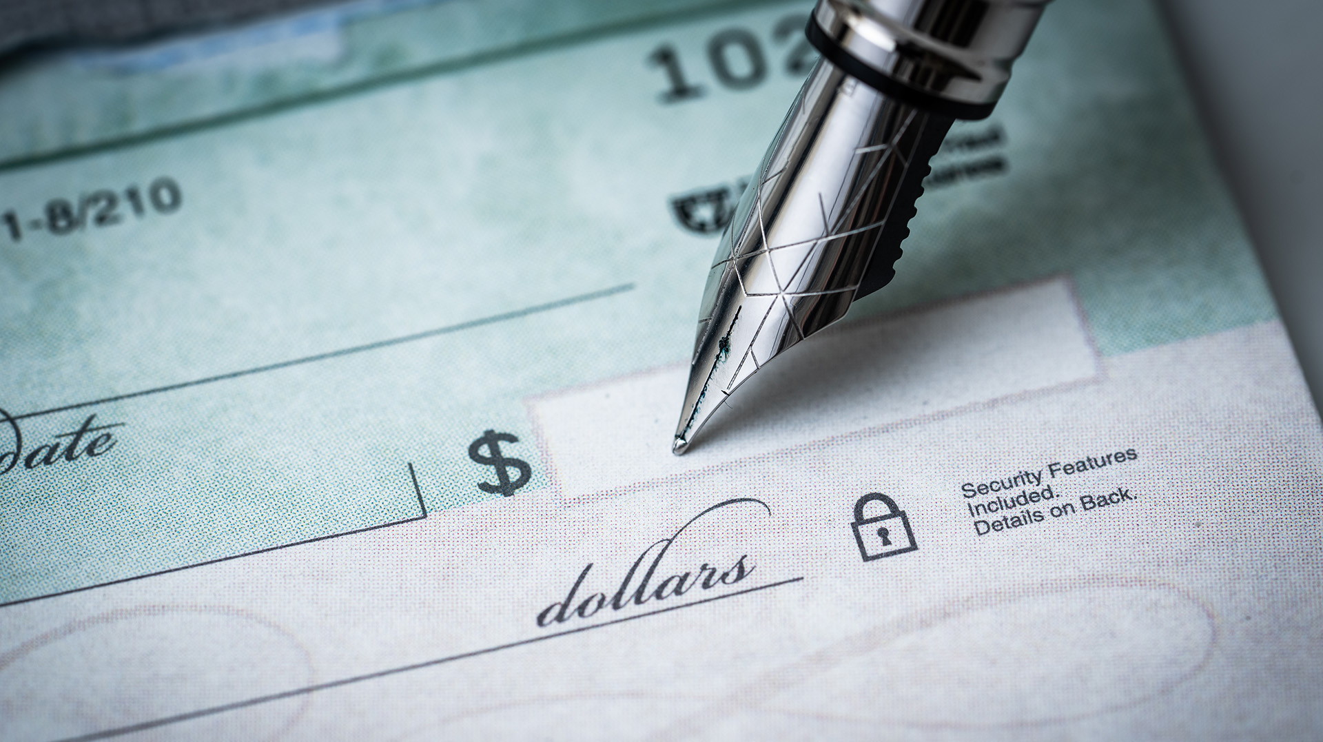 pen writing on a blank check