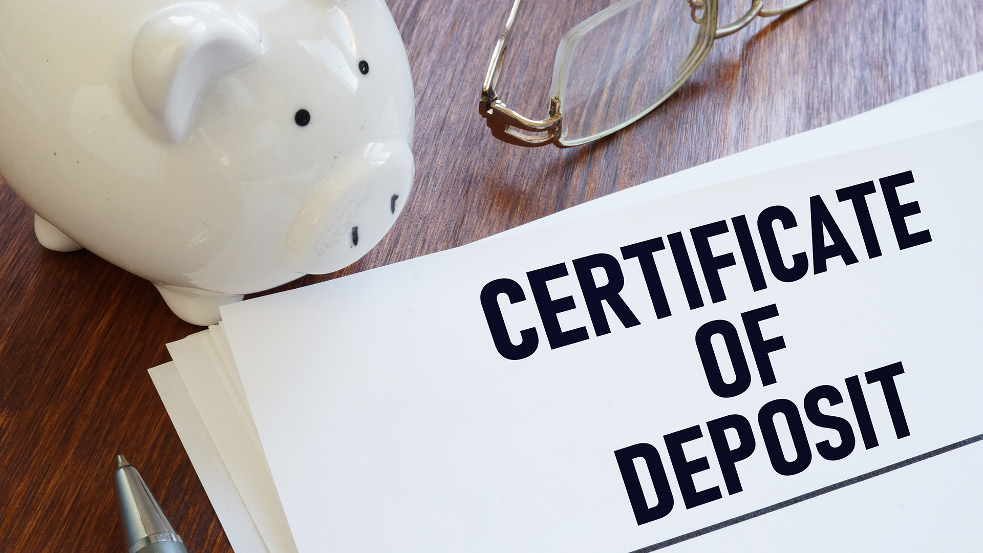 piggy bank and paper that says certificate of deposit