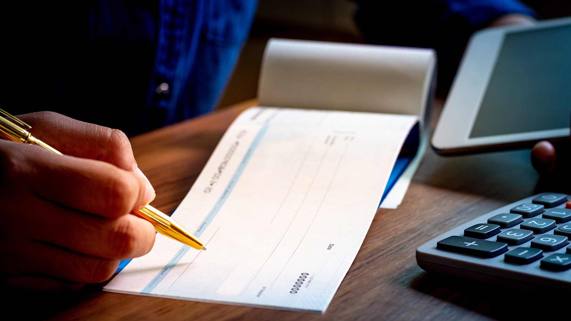 person filling out a paper check