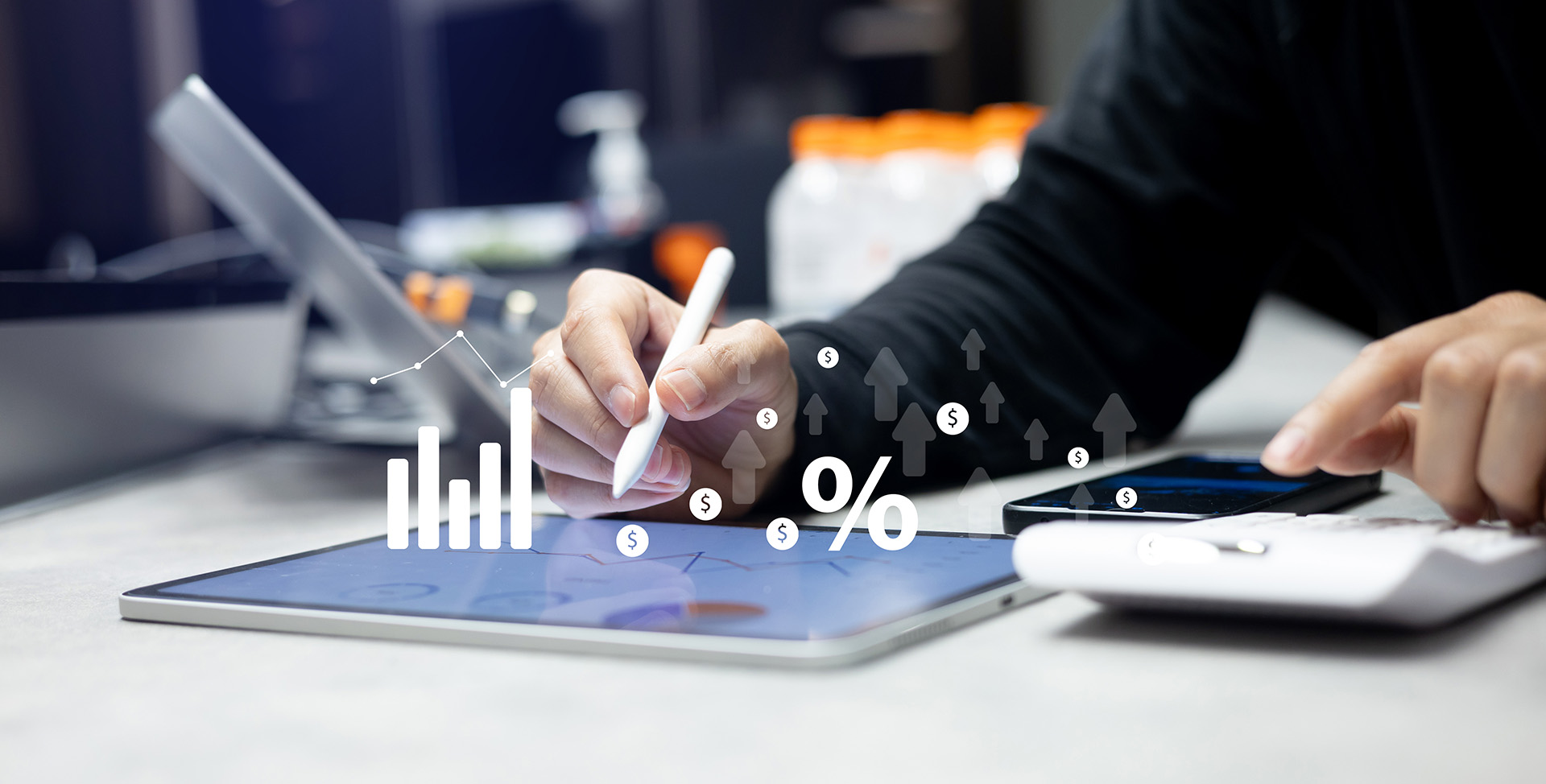 person working with a tablet and calculator